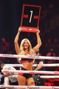 Round 7 boxing ring card held by a ring girl.