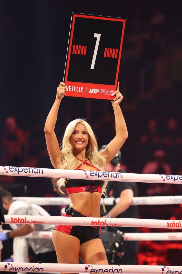 Round 7 boxing ring card held by a ring girl.