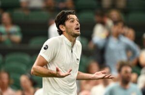 Taylor Fritz reacting during a Wimbledon tennis match.