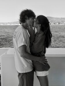 Black and white photo of a couple kissing.