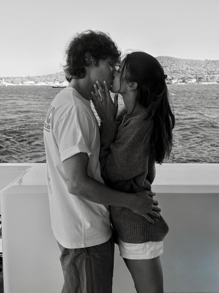Black and white photo of a couple kissing.
