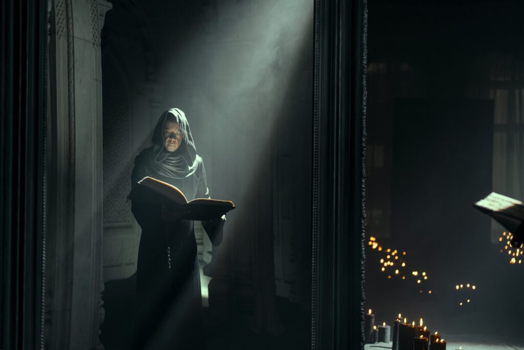 Adrian Lester as Destiny consults his book in The Sandman
