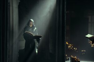 Adrian Lester as Destiny consults his book in The Sandman