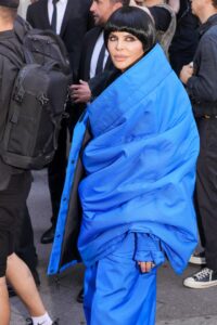 Lisa Rinna at the Balenciaga show wearing a bright blue outfit.