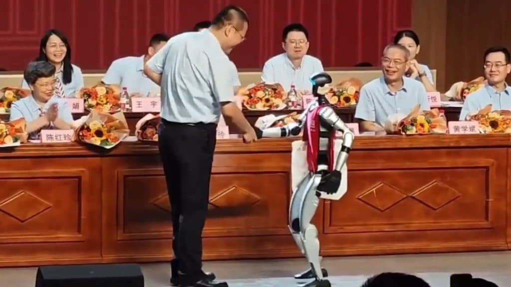 Robot shaking a teacher's hand