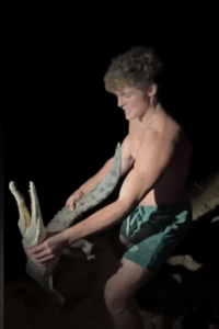 Man wrestling a crocodile.