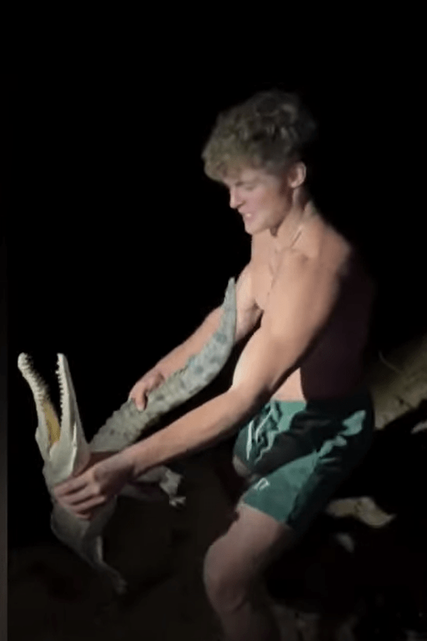 Man wrestling a crocodile.