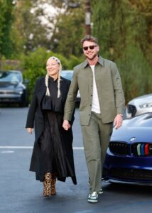 Sia and Harry Jowsey holding hands and leaving a restaurant.