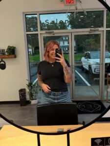 Woman taking a selfie in a salon.