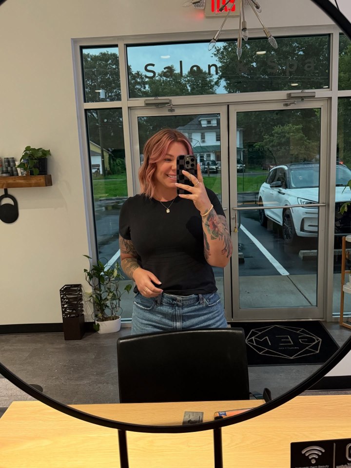 Woman taking a selfie in a salon.