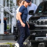 Tom Cruise and Ana de Armas holding hands while walking.