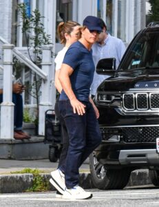 Tom Cruise and Ana de Armas holding hands while walking.
