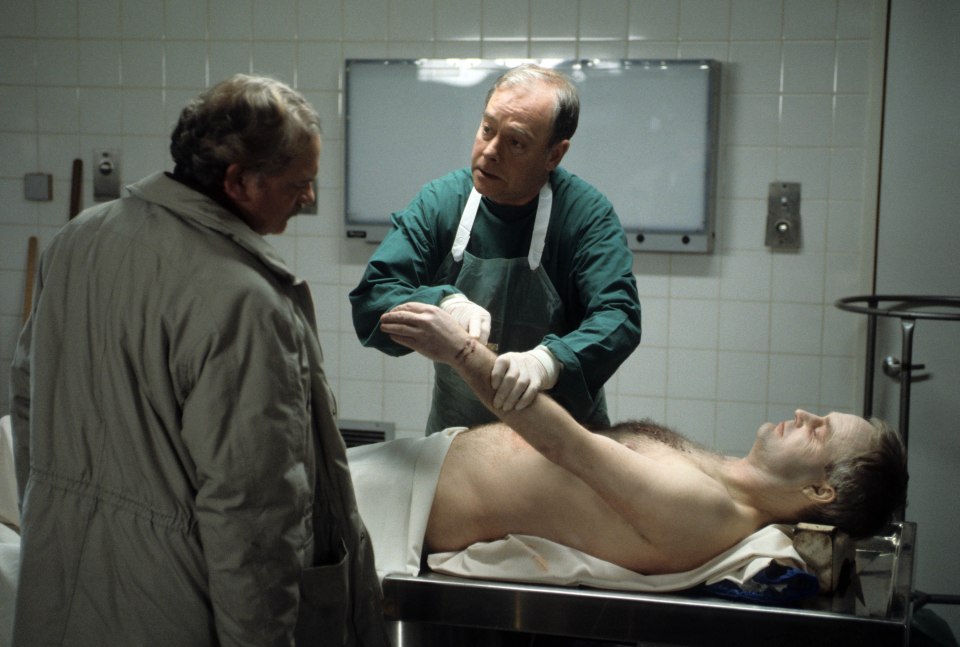 Scene from A Touch of Frost showing a pathologist examining a body.