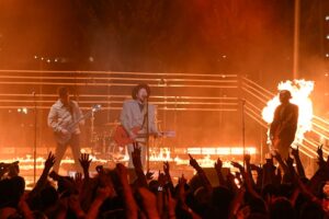 Fall Out Boy performing onstage with fire.