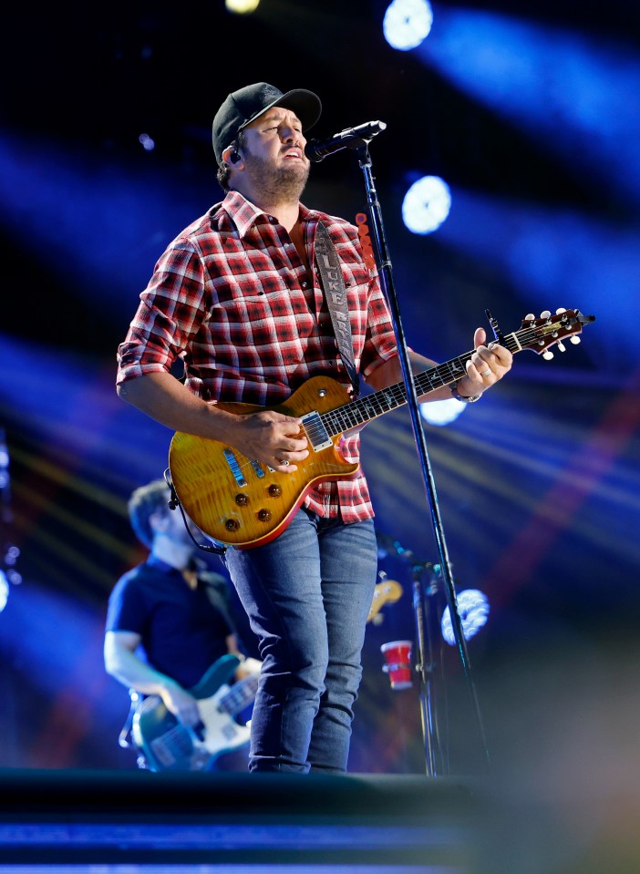 Luke Bryan performing onstage at the CMA Music Festival.