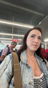 Woman in airport gate area made $750 by accepting compensation for an overbooked flight and rebooking a cheaper flight.