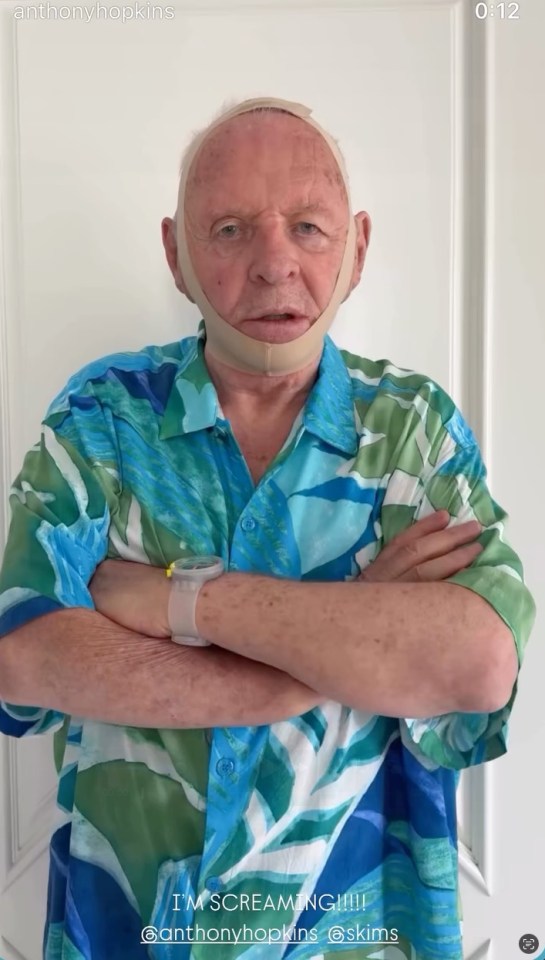 Anthony Hopkins wearing a face shaper and a blue shirt.