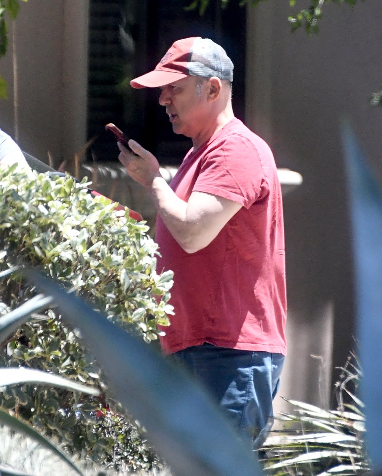Paris Themmen, former child actor, using a cellphone outdoors.