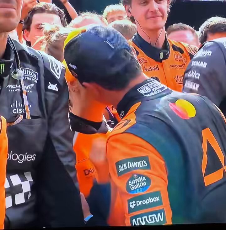 Race car driver being congratulated.