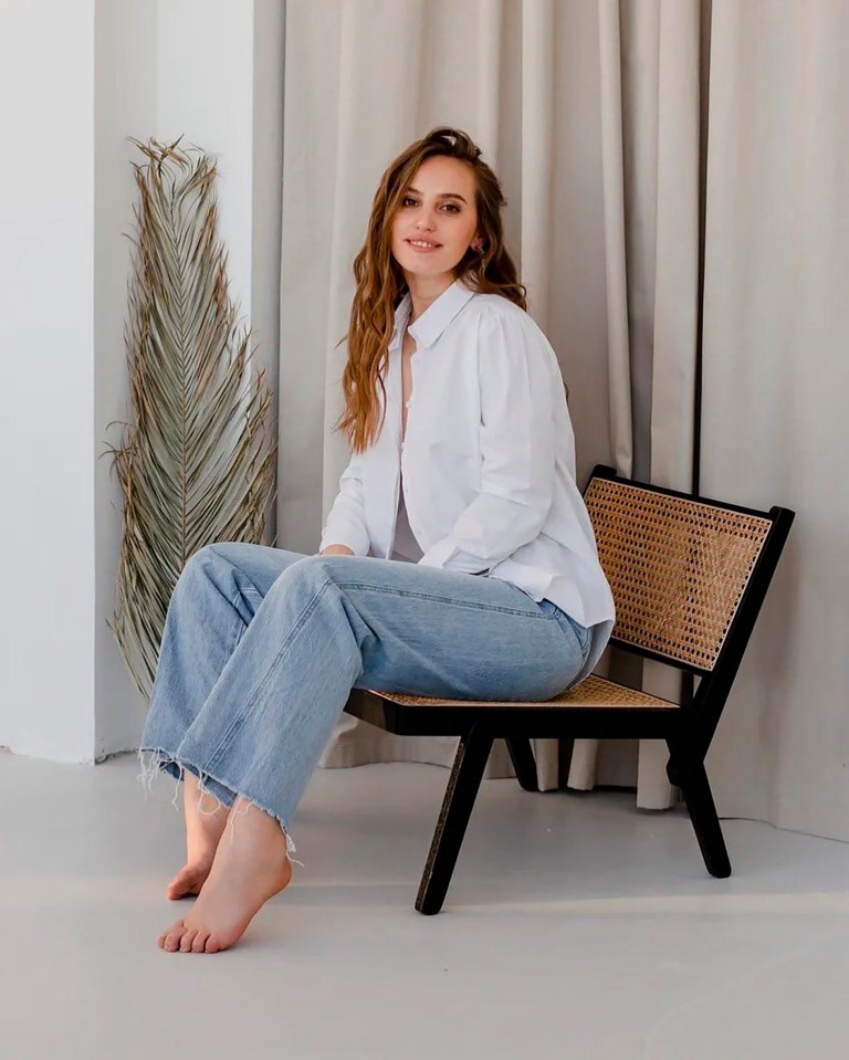Woman sitting on a chair.