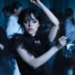 Jenna Ortega as Wednesday Addams dances with her hands above her head in "Wednesday."