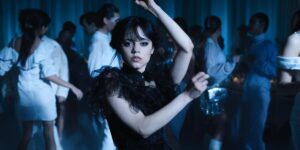 Jenna Ortega as Wednesday Addams dances with her hands above her head in "Wednesday."