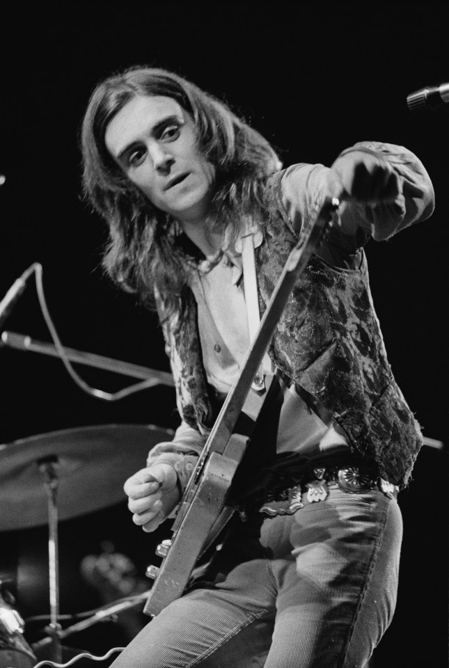 Black and white photo of Terry Reid playing guitar on stage.