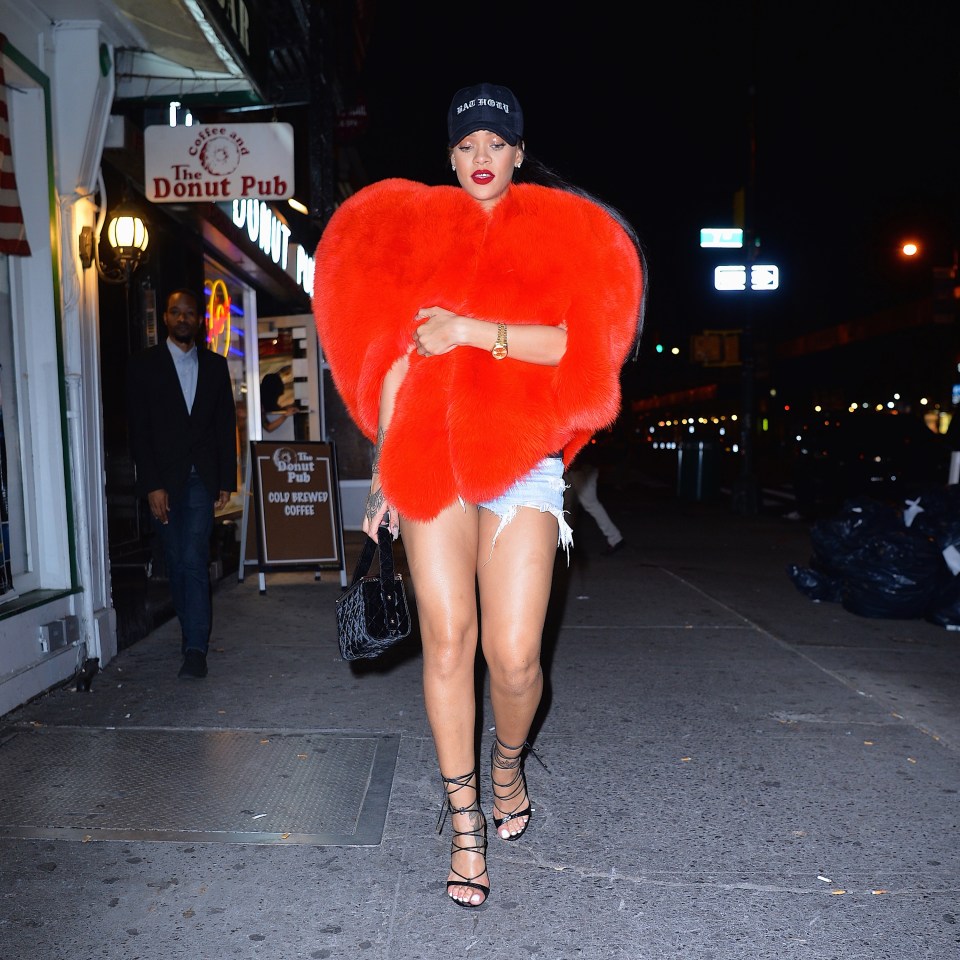 Rihanna in Manhattan wearing a red heart-shaped fur coat.