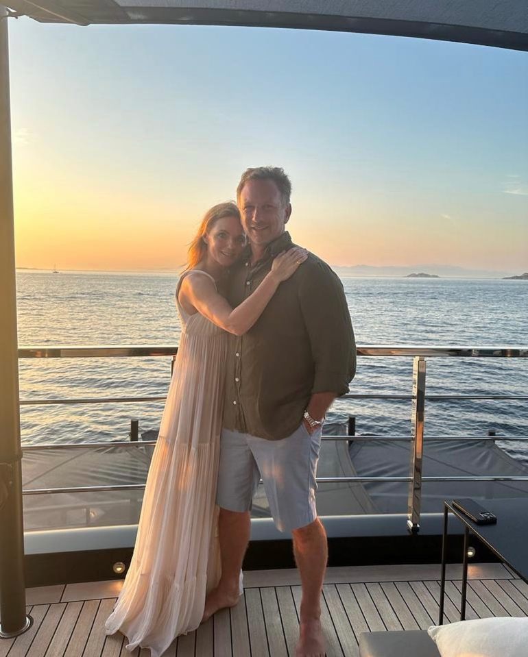 Couple embracing on a yacht deck at sunset.