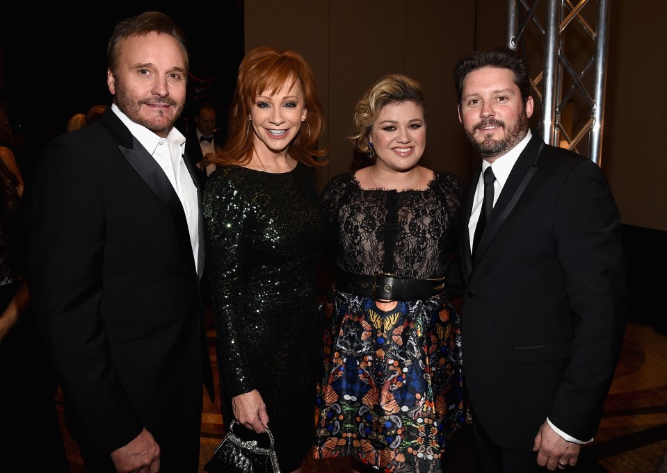 Narvel Blackstock, Reba McEntire, Kelly Clarkson, and Brandon Blackstock at an event.