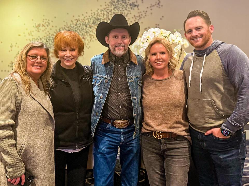 Group photo of Reba McEntire and Brandon Blackstock with three other people.