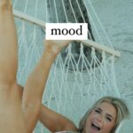 Emily Elizabeth lounges on a hammock while wearing a bikini.