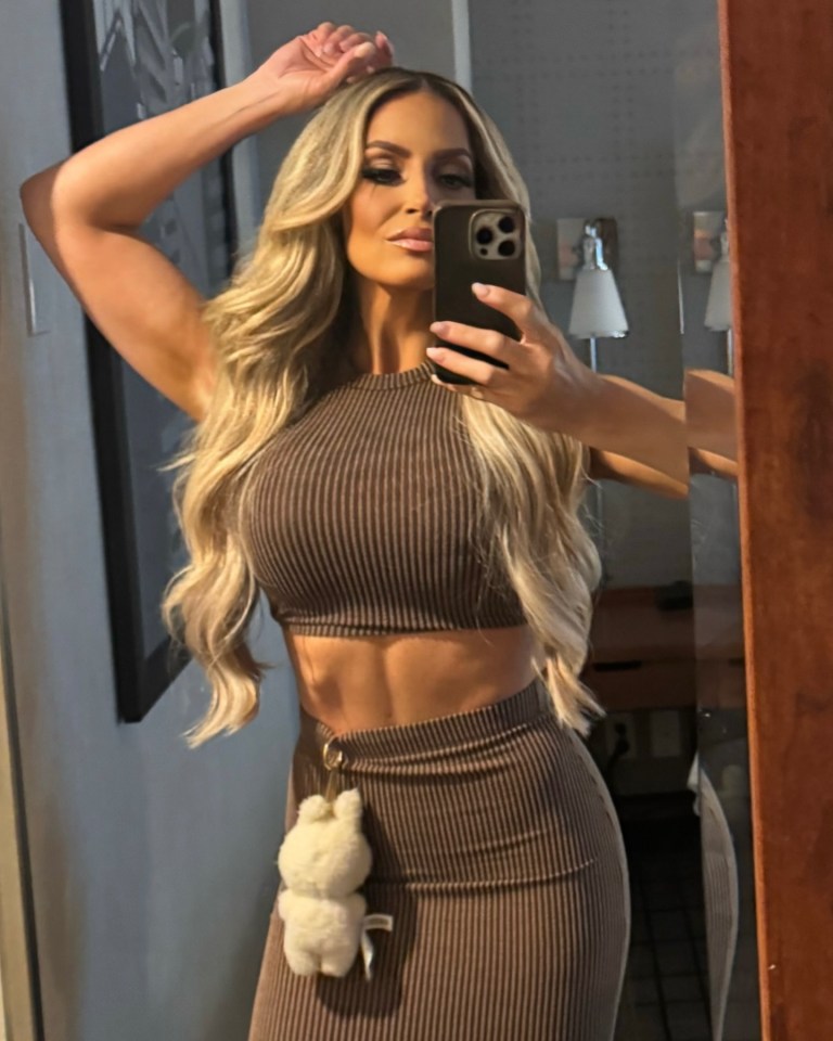 Selfie of Trish Stratus in a brown ribbed crop top and skirt.