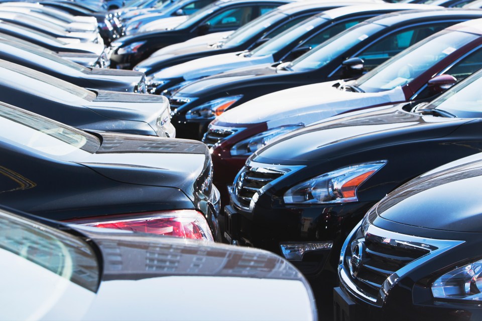 Row of parked cars in a lot.