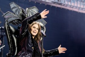 Ozzy Osbourne on stage in a bat-winged chair.