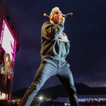 Adam Levine sings on stage with Maroon 5