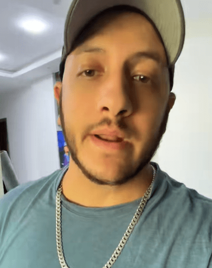 Man in baseball cap describing a near car scam on TikTok.