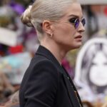 Kelly Osbourne viewing tributes to her father.