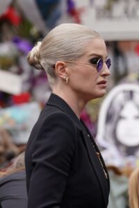 Kelly Osbourne viewing tributes to her father.