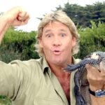 Steve Irwin holding a small alligator.