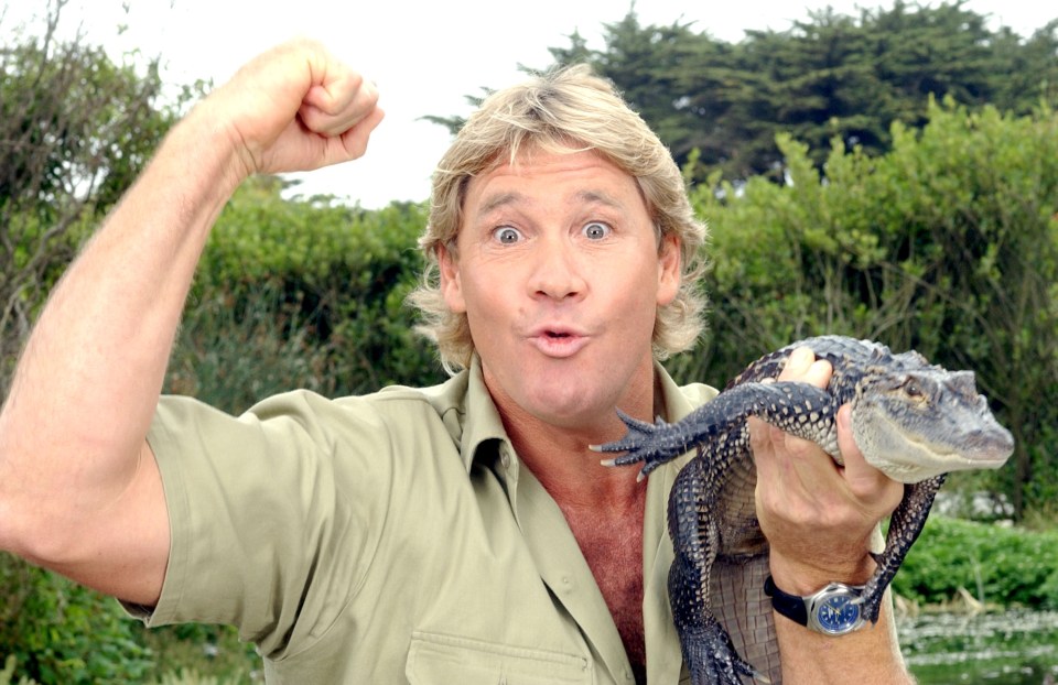 Steve Irwin holding a small alligator.