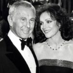 Black and white photo of Johnny Carson and Joanna Holland at a party.