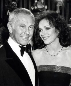 Black and white photo of Johnny Carson and Joanna Holland at a party.