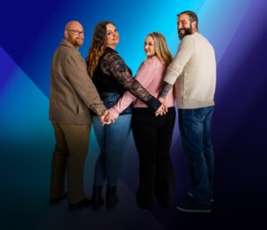 Polyamorous couple holding hands.