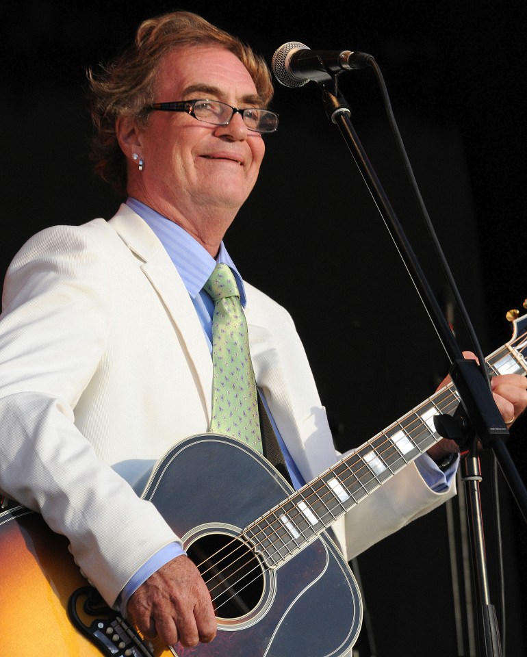 Black and white photo of Terry Reid performing on stage with a guitar.