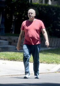 Paris Themmen, former child actor, walking down a street.